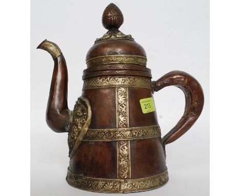 An Islamic copper and white metal coffee / teapot. The copper tapering body with large handle and spout, acorn finial lid abo