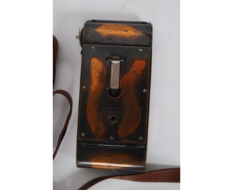 A vintage Carbine Butchers Watch Pocket folding camera ' Tropical Model ' with associated case and photography accessories (l