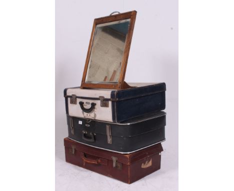 A stack of vintage suitcases to include leather example, retro example and also an oak framed easel mirror