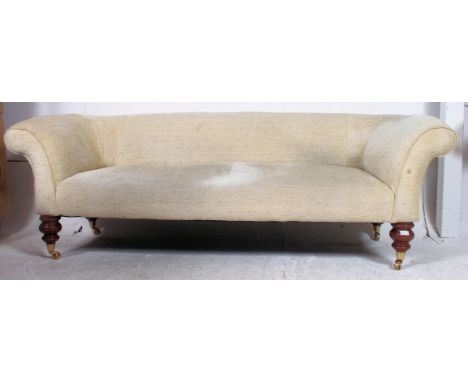 A Victorian mahogany large Chesterfield sofa settee raised on turned legs with brass castors having stunning barrel shaped ar