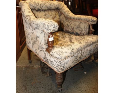 An Edwardian shabby chic mahogany salon armchair. Raised on turned legs with ceramic castors - ready to by re-upholstered