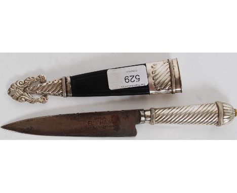 A decorative Islamic style white metal dagger with stunning detailed scabbard cast in relief.