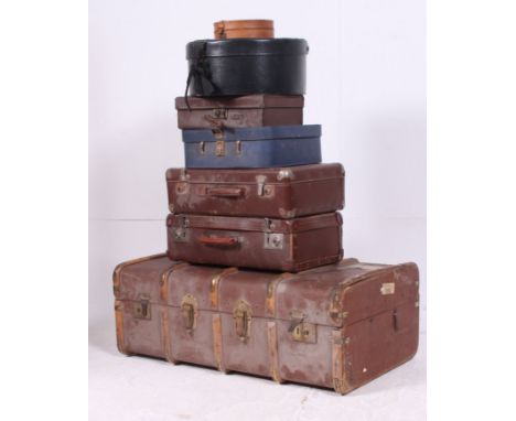 A stack of vintage trunks to include a canvas and wooden bound steamer trunk, retro suitcases. leather examples etc H33 W92 D