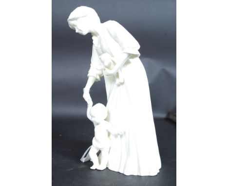 A Royal Worcester figurine of a mother and child ~ First Steps by Glenis Devereux being marked to the base. H20cm