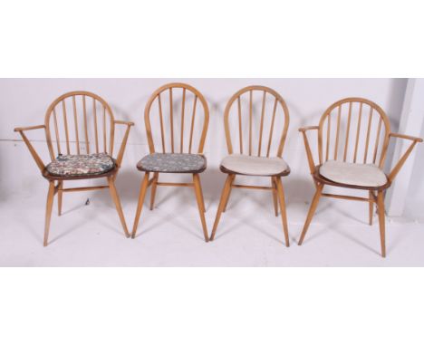 A set of 4 1970's vintage Ercol hoop back dining chairs raised on turned legs with panel seats and arched back rests H80 W63 