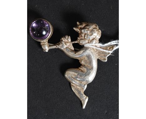 A silver hallmarked broach of a Cherub playing a pipe blowing a bubble set with an amethyst stone 8.7g