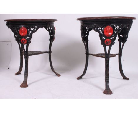A pair of old cast iron circular pub tavern tables / table having relief cast portrait busts of Baden Powell above a cartouch
