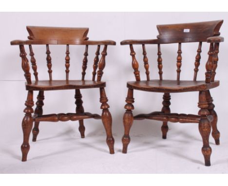 An excellent pair of Victorian beech and elm wood Smokers Bow Windsor armchairs. Raised on bobbin turned legs with saddle sea