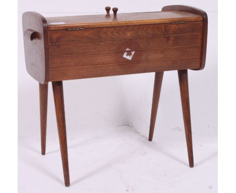 A vintage 1950's retro cantilever / metamorphic sewing box raised on tapered supports having sectional body H46 W48 D27 cm