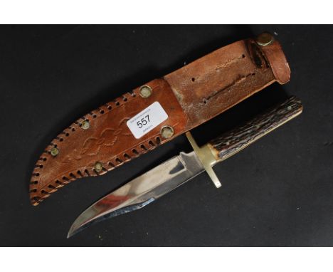 A stag horn handled bowie knife complete with the leather scabbard, the balde inscribed for Beckfield of Sheffield