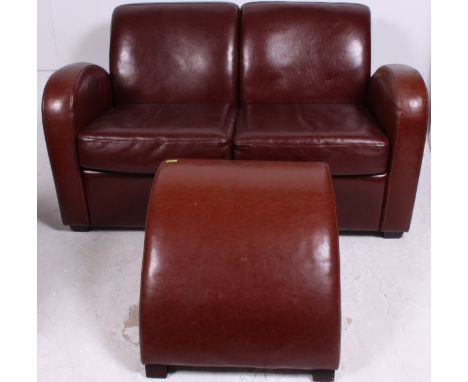 A 20th century brown / tan leather art deco style two seater leather sofa with curved sweeping arm detailing and half moon ma