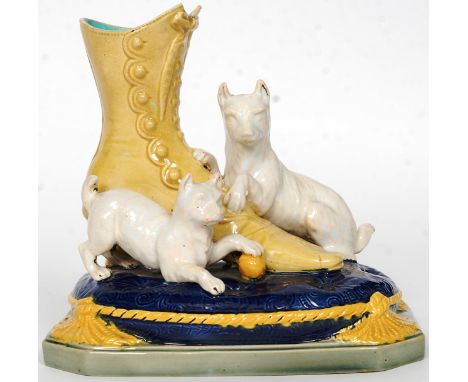 A Victorian 19th Century Brown Westhead Moore & Co majolica terrier and boot spill vase, circa 1870-1880. The central boot ad