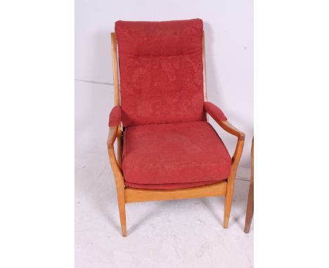 A pair of retro 1970's vintage Cintique armchairs having the original upholstered frames being raised on squared supports wit
