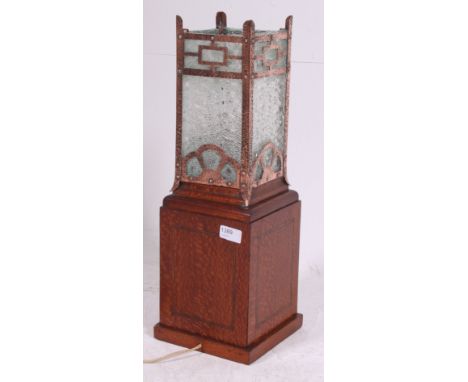 An Edwardian oak glass table lamp having fitted square copper and frosted glass shade atop over the rectangular oak box base.
