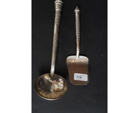 A Siam white metal ladle together with a matching cake slice being cast in repousse with chase decoration