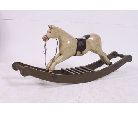 A small painted rocking horse, in the manor of Ayres, with bow sleigh rocker H42 W94 D18cm