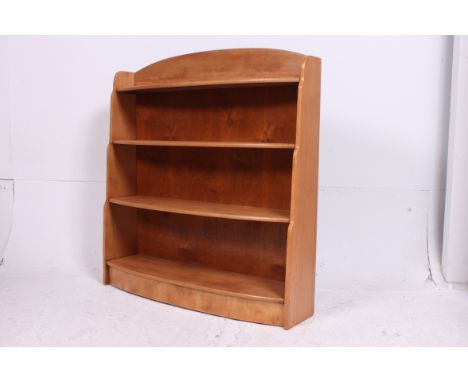 A good quality 20th century beech wood bow front open window bookcase cabinet having central shelves with gallery top