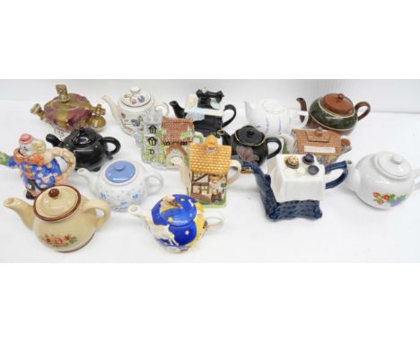 A collection of seventeen ceramic novelty teapots includes a crown, house and a clown  **PLEASE NOTE THIS LOT IS NOT AVAILABL