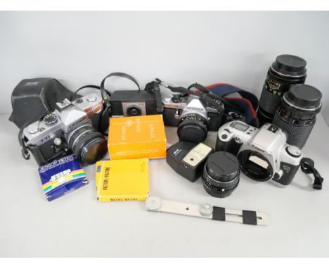 A collection of cameras and lenses, to include ME Super Pentax, Canon E05, and TTL Petri.