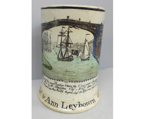A large 19th century Sunderland creamware frog mug with scene of the Iron Bridge over The Wear, writing to front "Thos. and A