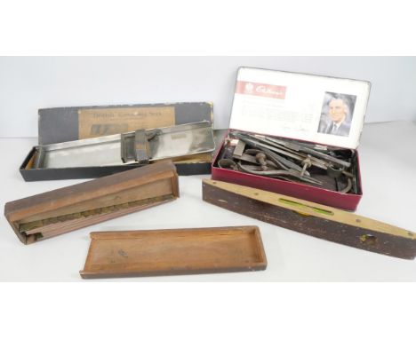A collection of tools; callipers marked Hawksley, Moore &amp; Wright, a Rabone level, a composing stick, etc.