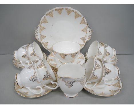 A porcelain Royal Albert tea service having gilt flowers and lattice comprising of eight teacups, six saucers, six side plate
