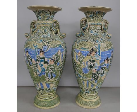 A pair of twin handle ceramic oriental vases with blue and green hand painted repeated patterns and scenes.  **PLEASE NOTE TH