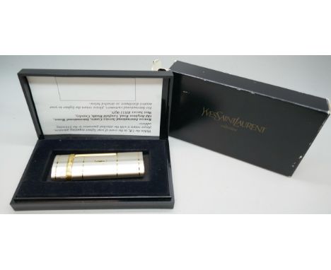 A Yves Saint Laurent lighter with inscription, cased