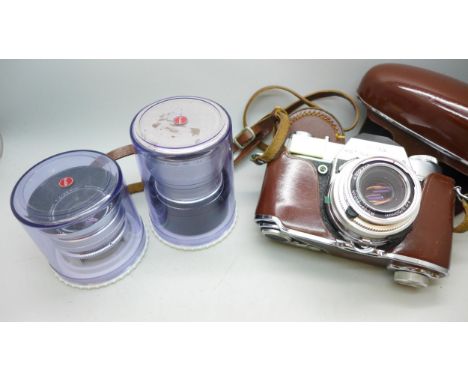 A Kodak Retina Reflex S camera with lens, two other lenses, manual and camera case