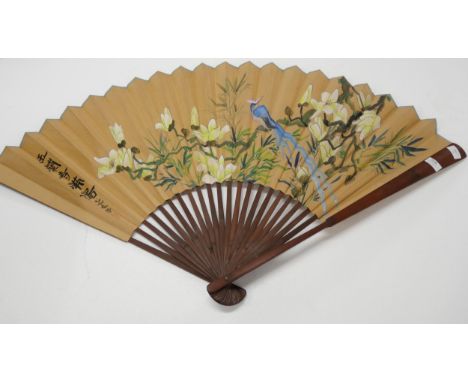 A large hand painted oriental decorative wall fan, having floral bird motif and Chinese characters.
