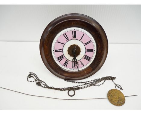 In the style of T. Lovejoy of Wimbledon postman's alarm wall clock. Featuring enamel dial with roman numeral marker and pink 