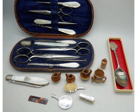 A cased manicure set with mother of pearl handles, a collection of doll's house accessories, a penknife and a silver spoon *N
