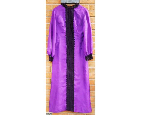 A collection of three vintage 1960s/1970s dresses including a Cresta Couture polka dot dress size 14, a long purple dress and