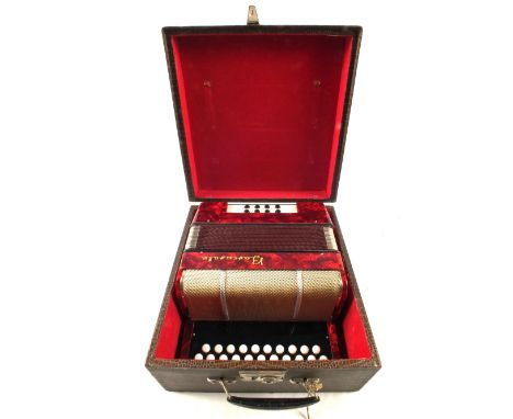 A small cased Baccarat accordion