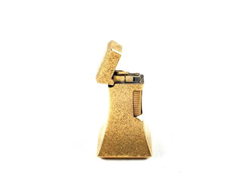 A Dunhill gilt metal table gas lighter of tapered rectangular form with textured finish