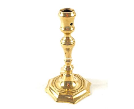 An early 18th Century baluster column Brass candlestick with ejector holes and incurved octagonal base, height 6 3/4"