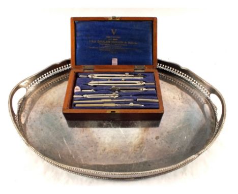 A Silver plated oval gallery tea tray and an Oak cased drawing set