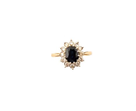 A 9ct Gold ring set with central Sapphire surrounded by Diamonds, size N