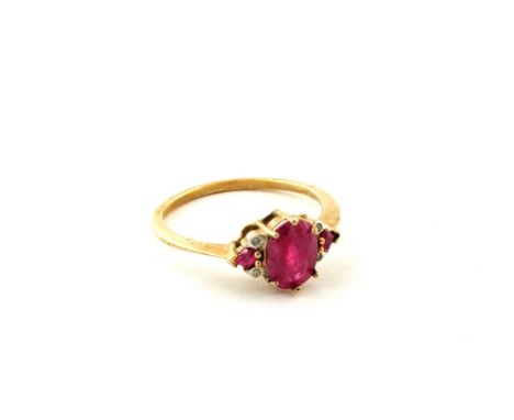A 9ct Gold ring set with a large pink stone with two small pink stones and four Diamond chip surround, size O