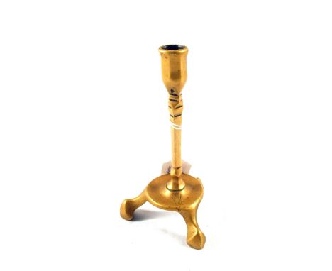 An 18th Century Brass candlestick in 15th Century style with octagonal socket, square stem and tripod, three legged base, hei