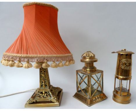 A table lamp with a pierced brass stand and fringed shade, 46cmH, together with a brass E Thomas and Williams Ltd miners lamp