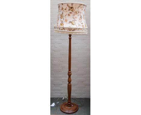 A pine floor lamp with baluster column and circular base, 140cmH, together with a floral cream lampshade