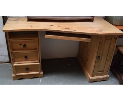 A rustic pine desk with a sliding skiver, one shelf above three drawers on the left and one cupboard on the right, 66 x 140 x