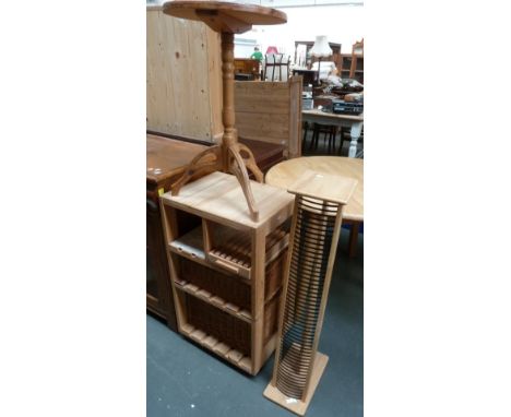 A pine CD rack, an extending pine kitchen table with circular top, 89cmD, a pine tripod table, top 39cmD and a pine kitchen t