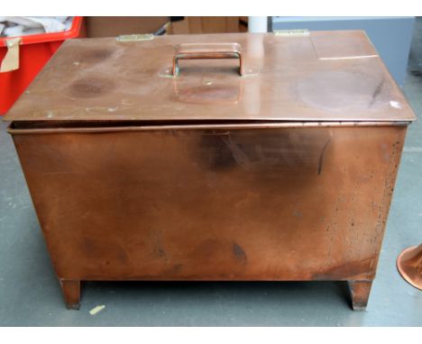 A copper storage chest containing a quantity of copper and brass items, including figurines, candlestick holders, butter melt