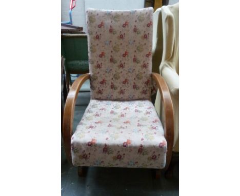 A vintage arm chair with curved arms upholstered in a floral pattern 99cmH