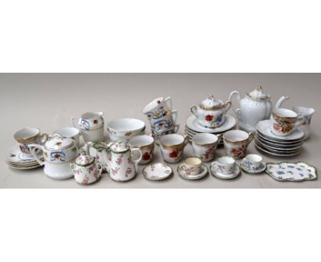 A child's tea service to include saucers, plates, cups, pots, milk jugs and others, possibly French, some handpainted and mar