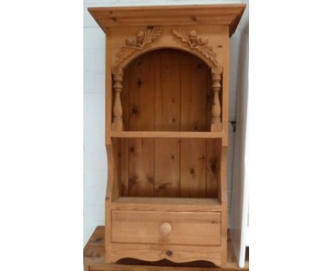 A pine hanging shelf with single drawer and carved acorn decoration, 80cmH, together with a pine corner shelf, 70cmH