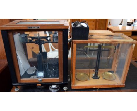 Two sets of scientific/ laboratory scales, each in glazed boxes with wooden frames