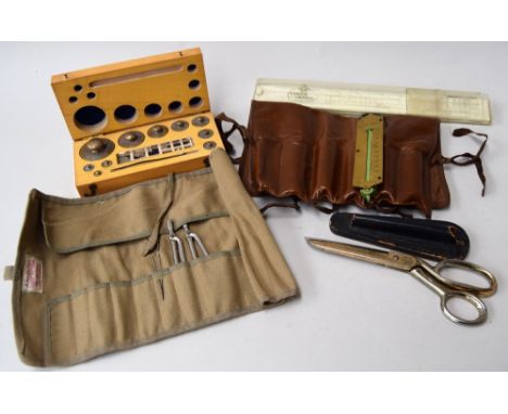 A selection of medical and scientific equiptment: a fitted wooden box of metal weights up to 200 grams, a vintage leather rol